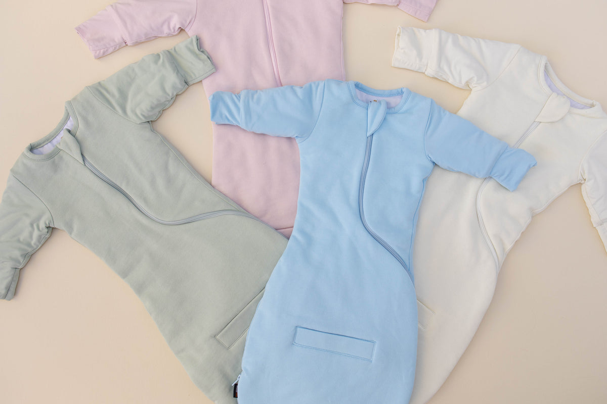 Swaddle Easy in Sage Green, Light Pink, Sky Blue and Cream, laid side by side
