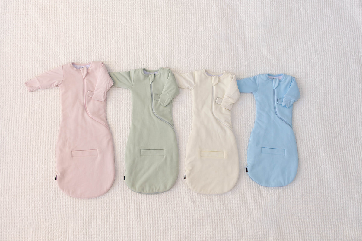 Swaddle Easy in Light Pink, Sage Green, Cream and Sky Blue, laid flat side by side