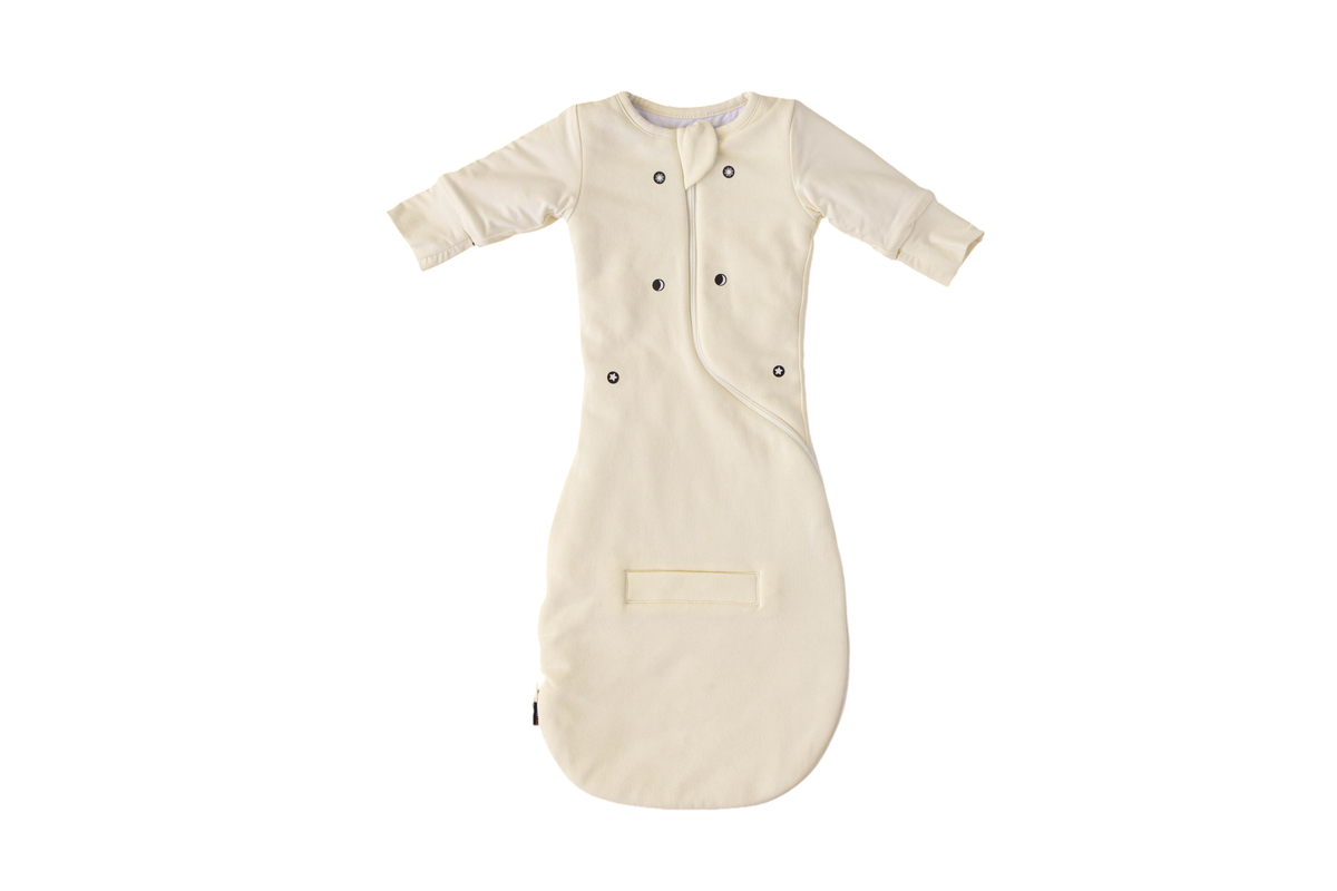 Swaddle Easy in Cream, laid flat, front view with the magnet dots, built-in mittens and leg pocket